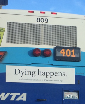 a "dying happens" banner on the back of a WTA bus
